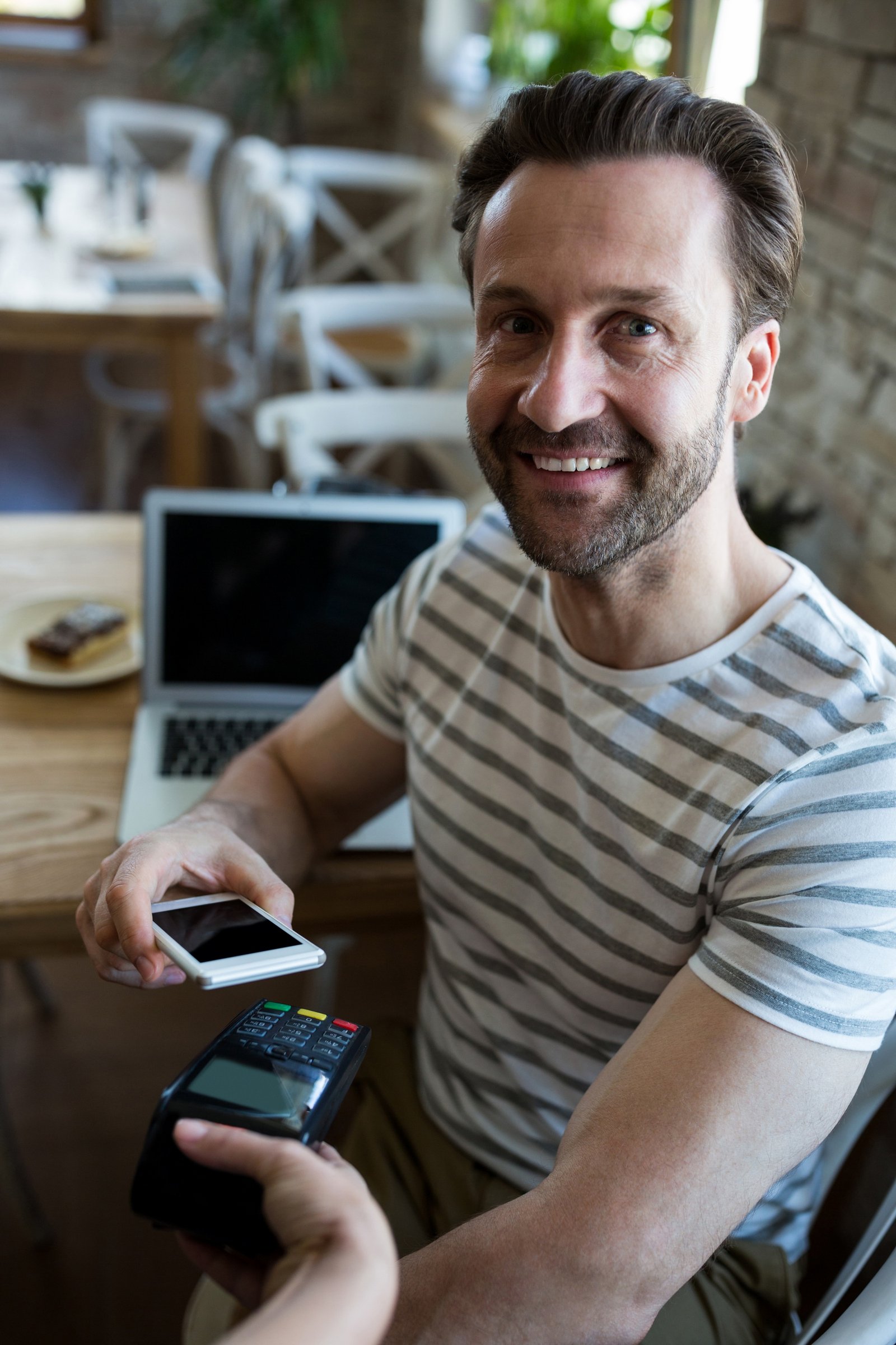 http://img.b2bpic.net/free-photo/smiling-man-paying-with-nfc-technology-mobile-phone_1170-2057.jpg
